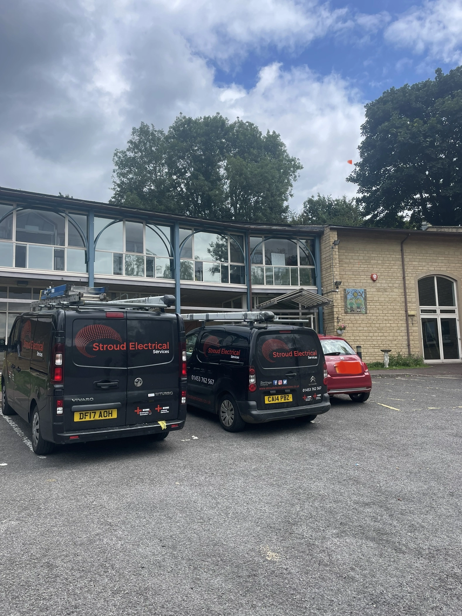 School Exterior with Electrician Vans