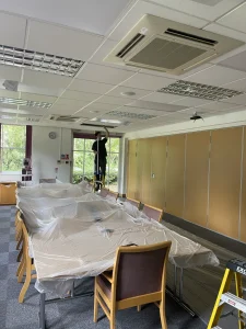 Lighting being installed in a conference room